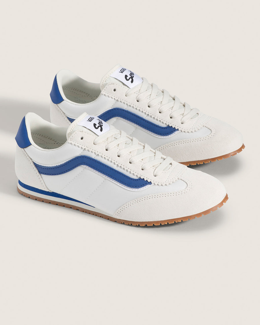 white vans super low pro sneaker with royal blue trim and iconic stripe