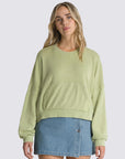 model wearing winter pear cropped sweatshirt with hi-lo hem, kangaroo pocket, and blouson sleeves 