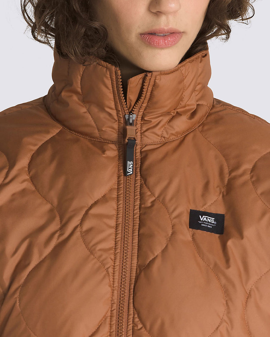 up close of model wearing brown quilted cropped jacket