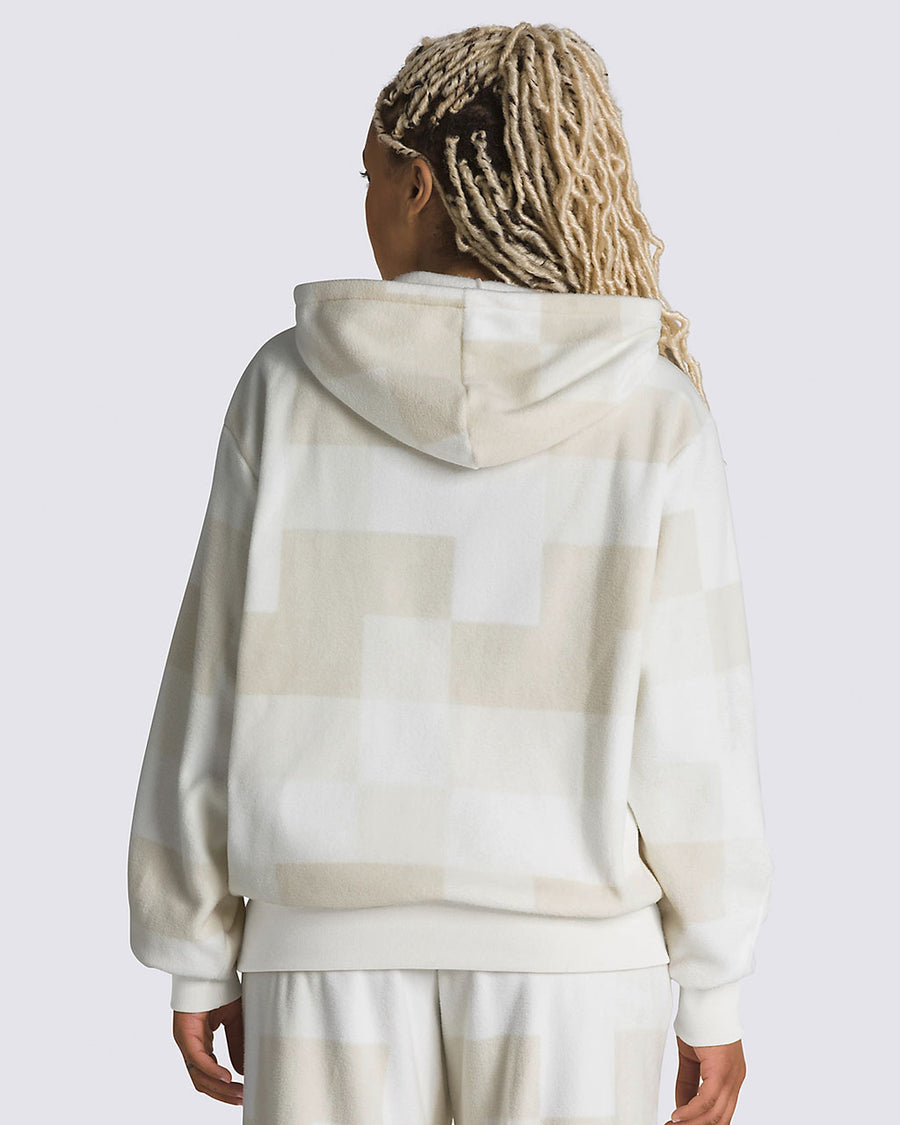 back view of model wearing tan and white checkered hoodie with kangaroo pocket and embroidered vans on left chest