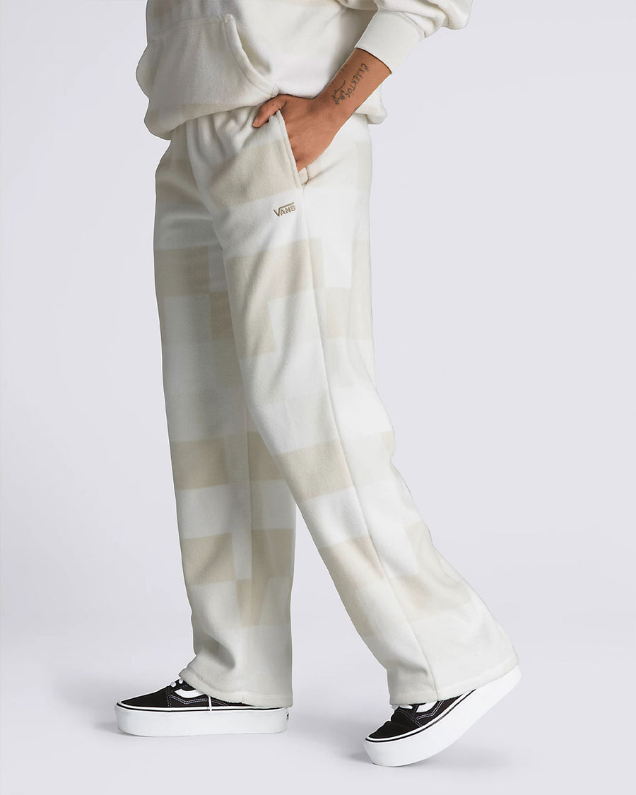 side view of model wearing tan and white checker sweatpants