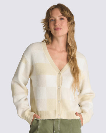 model wearing white and tan checkered cropped cardigan