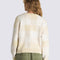 back view of model wearing white and tan checkered cropped cardigan