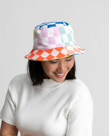 model wearing rainbow checkered patchwork bucket hat