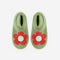 top view of green and stone marled slippers with coral flower and pom