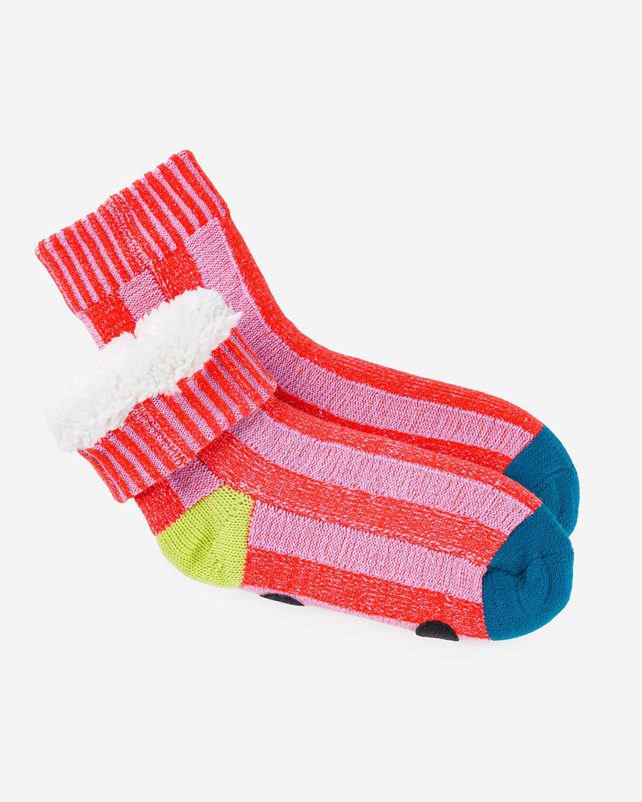 fuzzy interior of pink striped socks with yellow and blue trim and non-slip bottom