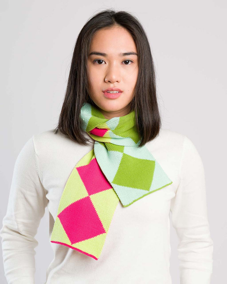model wearing yellow, pink, blue and green harlequin mini scarf