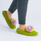 model wearing green slippers with multicolor poms on each