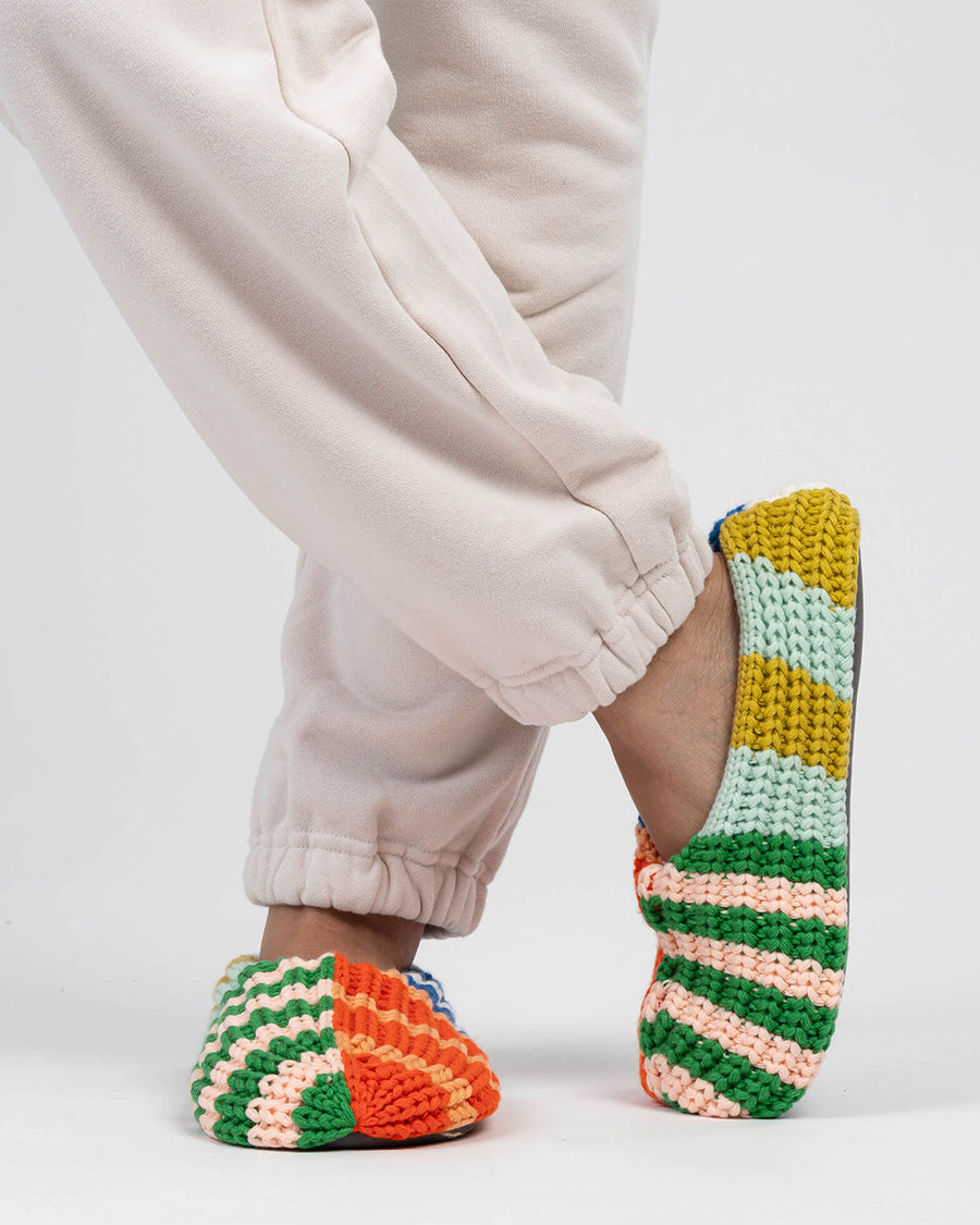 model wearing multi-color stripe fleece slippers
