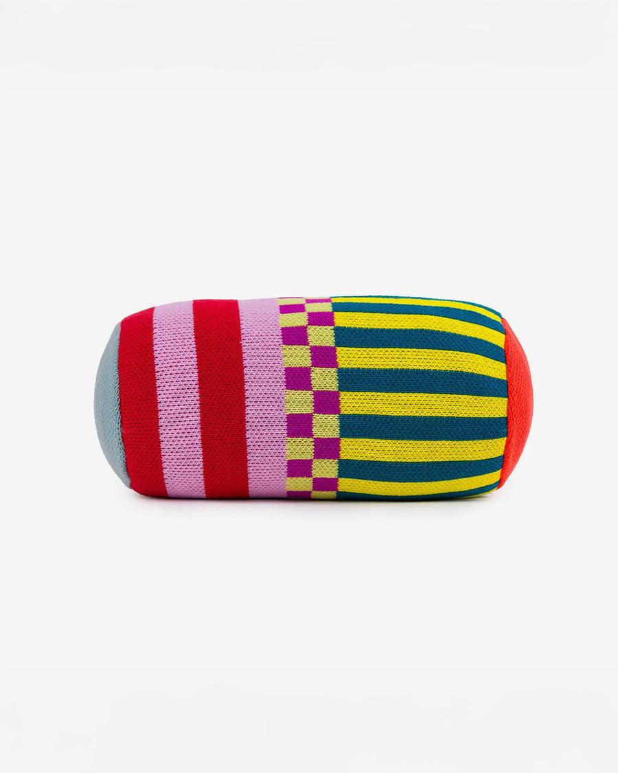 front view of multicolored bolster pillow with various stripes and checkered print
