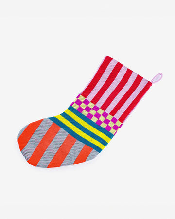 multicolored holiday stocking with various stripes and checkered print