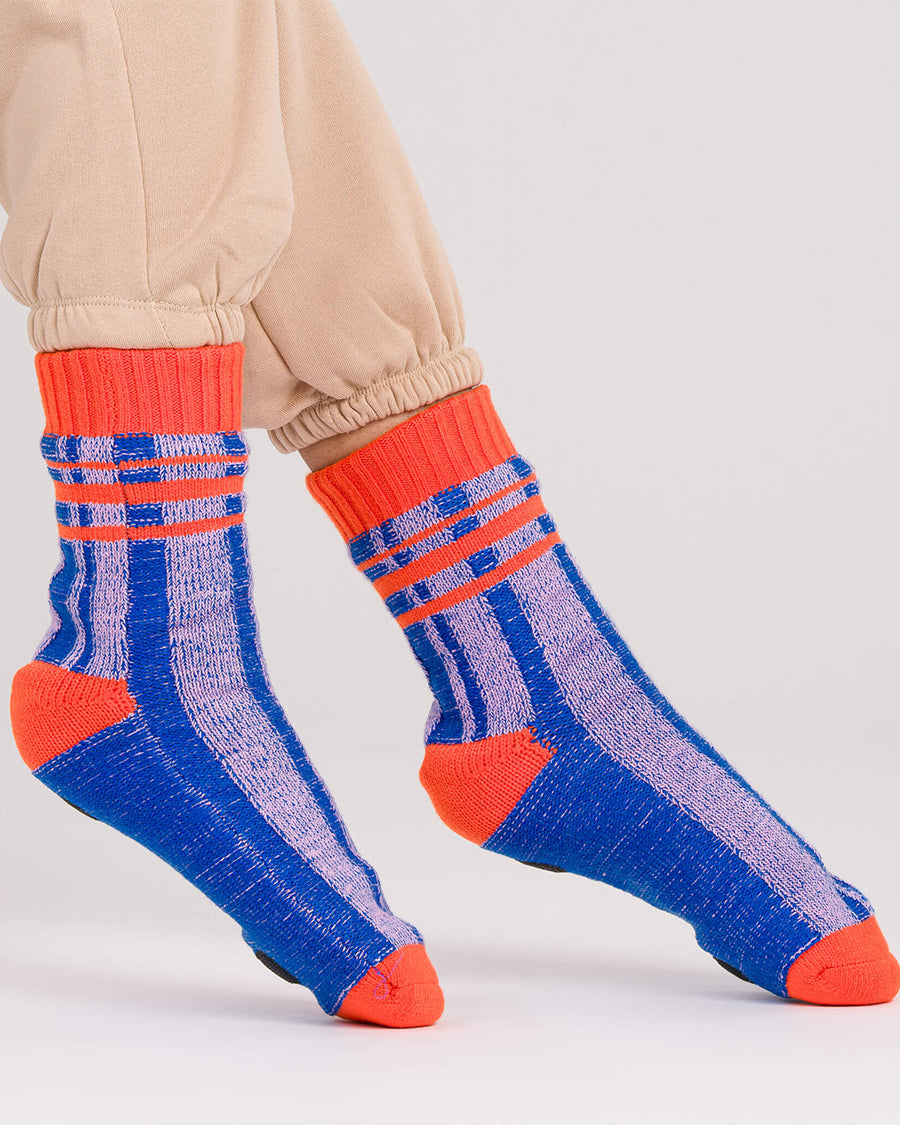 side view of blue and lilac stripe socks with bright red trim