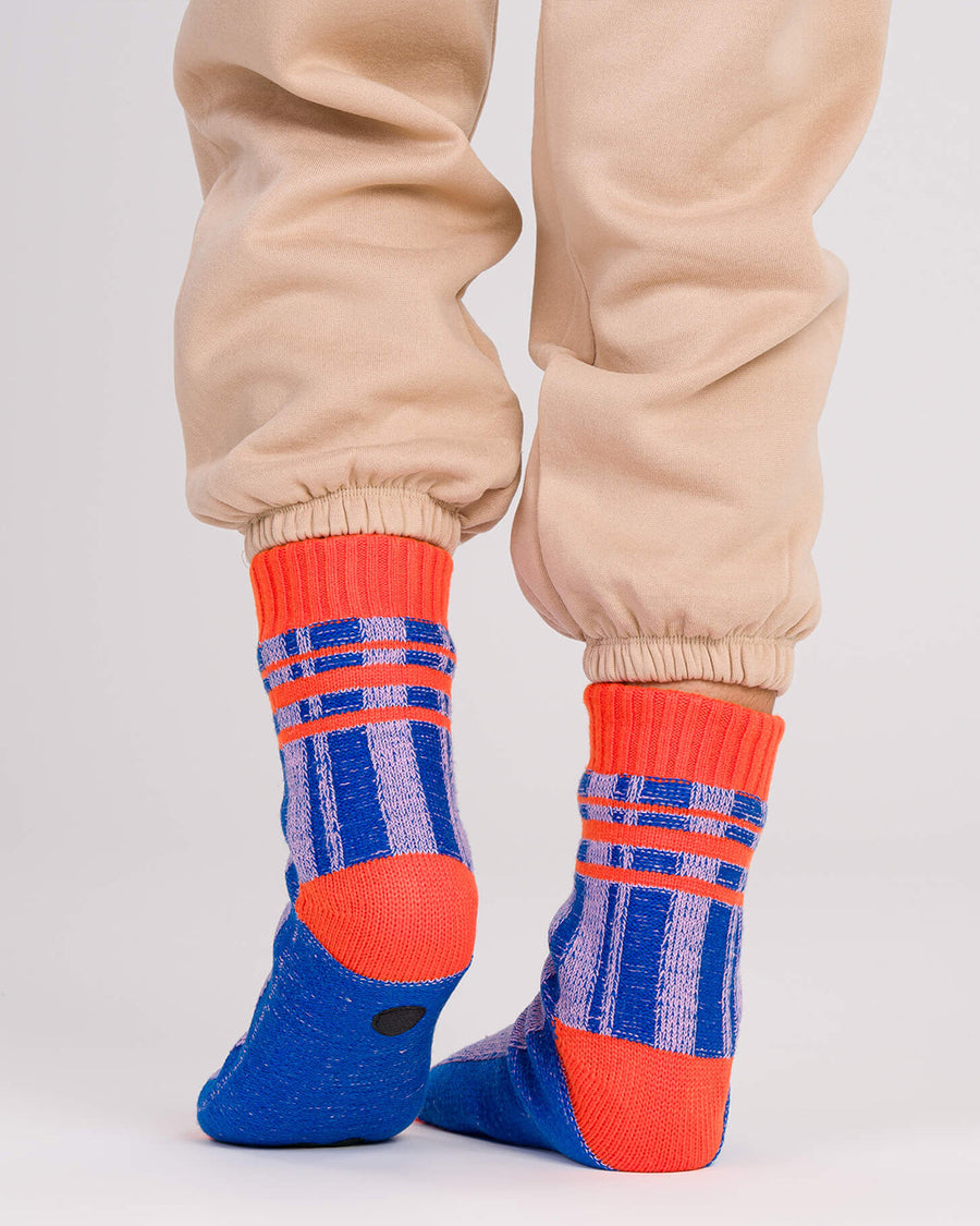 back view of blue and lilac stripe socks with bright red trim