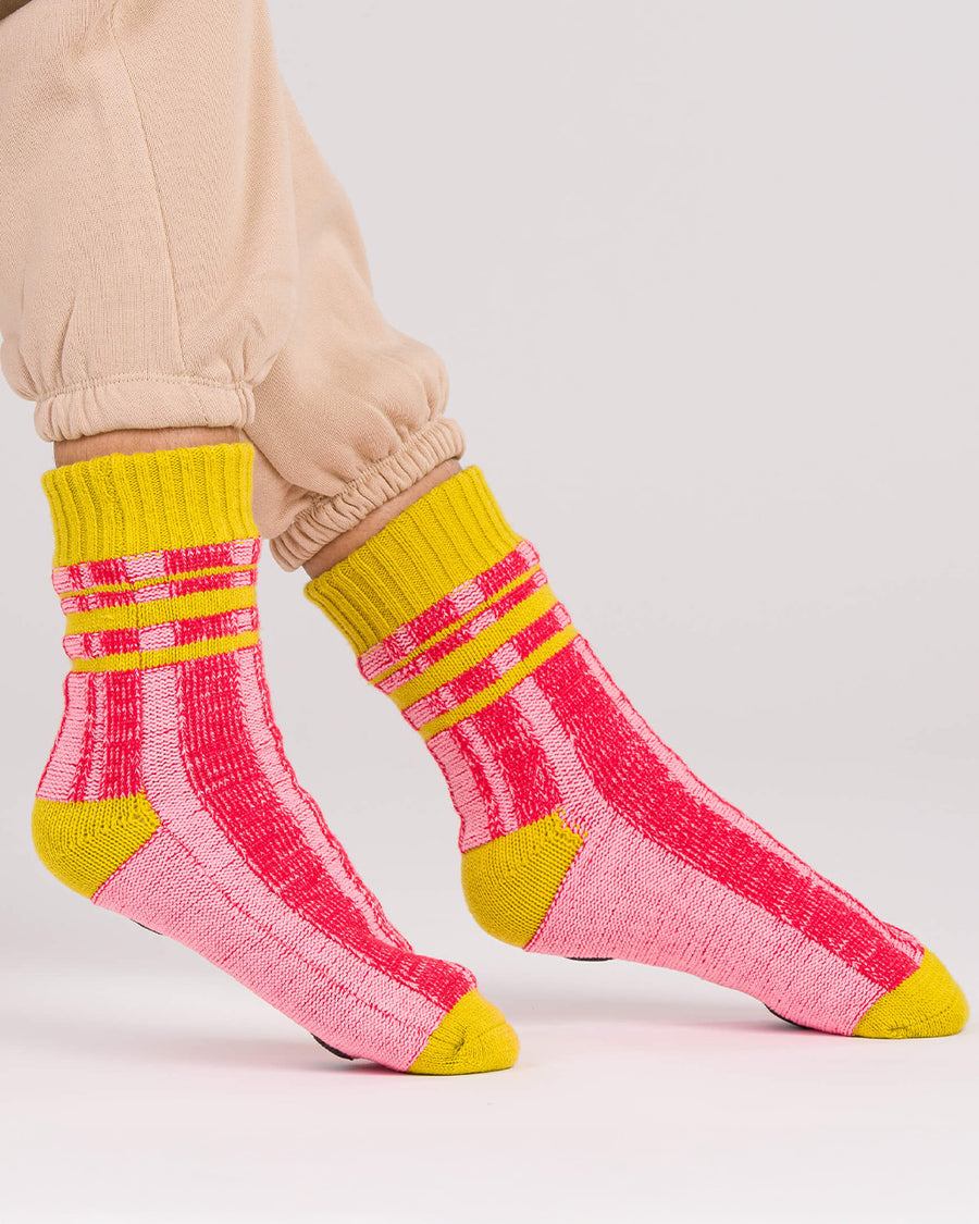 side view of pink and red stripe socks with chartreuse trim