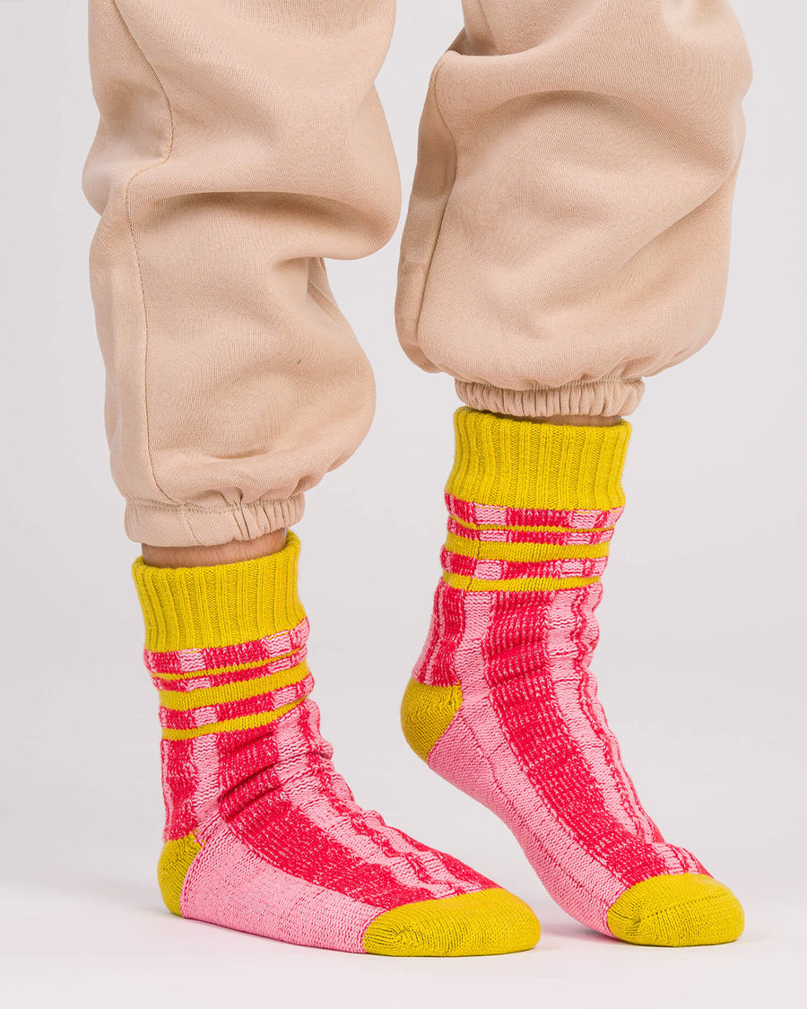 model wearing pink and red stripe socks with chartreuse trim