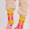 back view of pink and red stripe socks with chartreuse trim