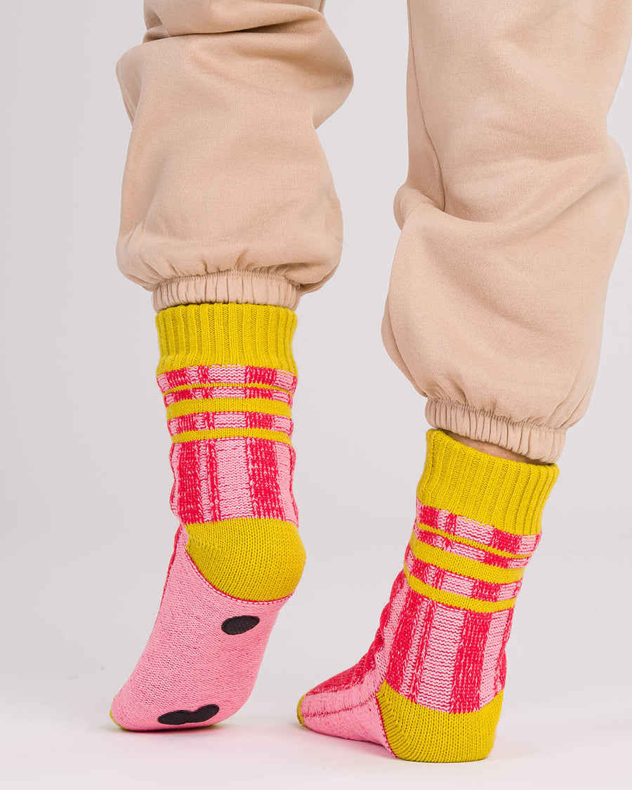 back view of pink and red stripe socks with chartreuse trim