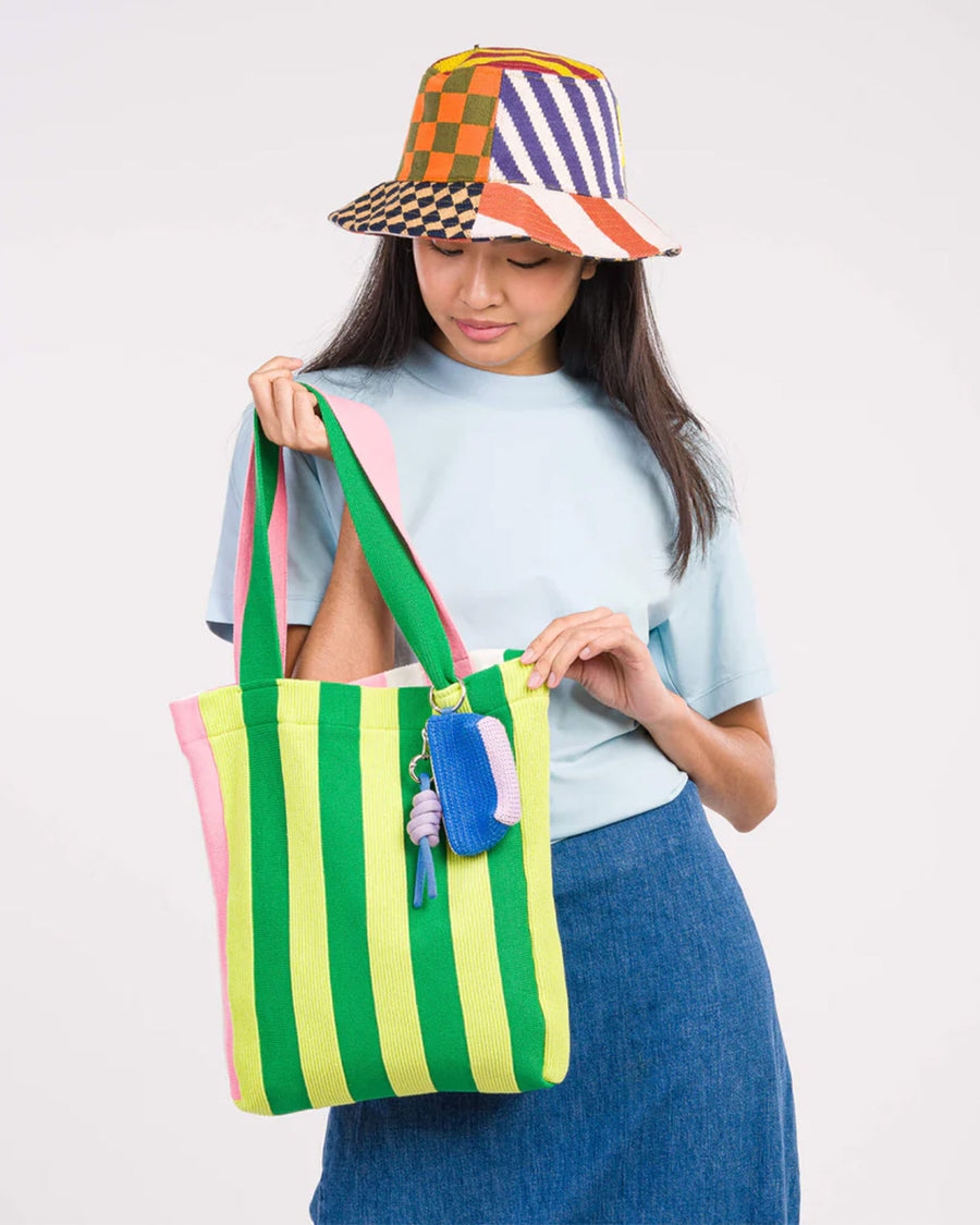 cobalt raffia bag charm with lavender bottom hanging from a bag