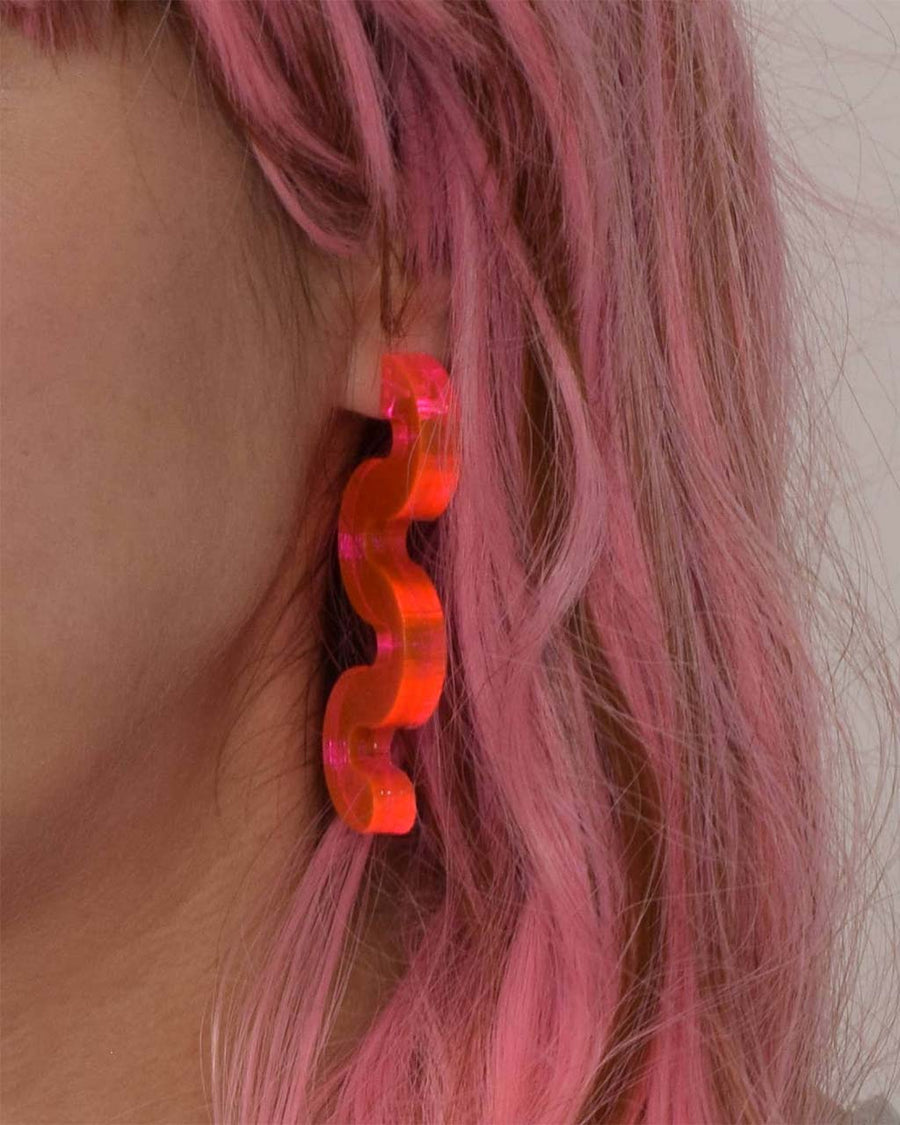 model wearing pink acrylic squiggle earrings