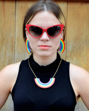 model wearing large rainbow studs