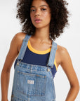 up close of model wearing light blue relaxed fit overalls