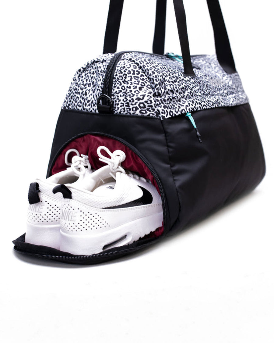 shoe compartment of duffle bag with black and white leopard top and black bottom