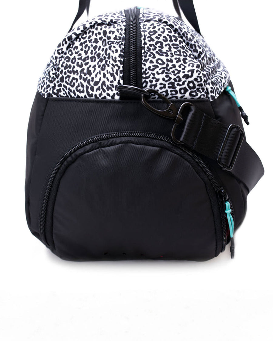 zipper shoe compartment of duffle bag with black and white leopard top and black bottom
