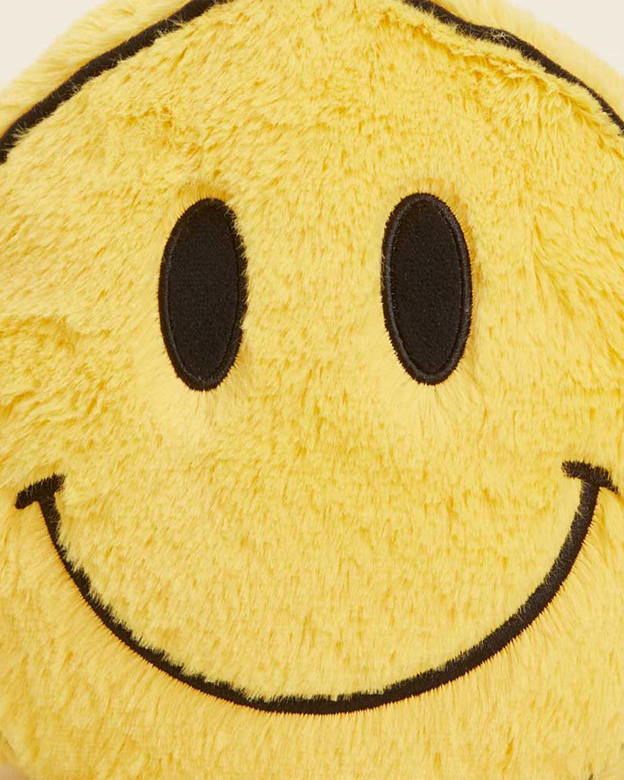 up close of face of yellow smiley face heating plush