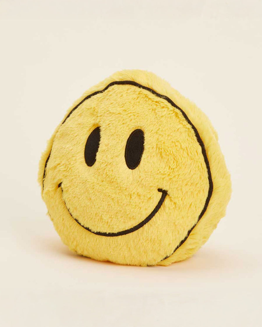 side view of yellow smiley face heating plush