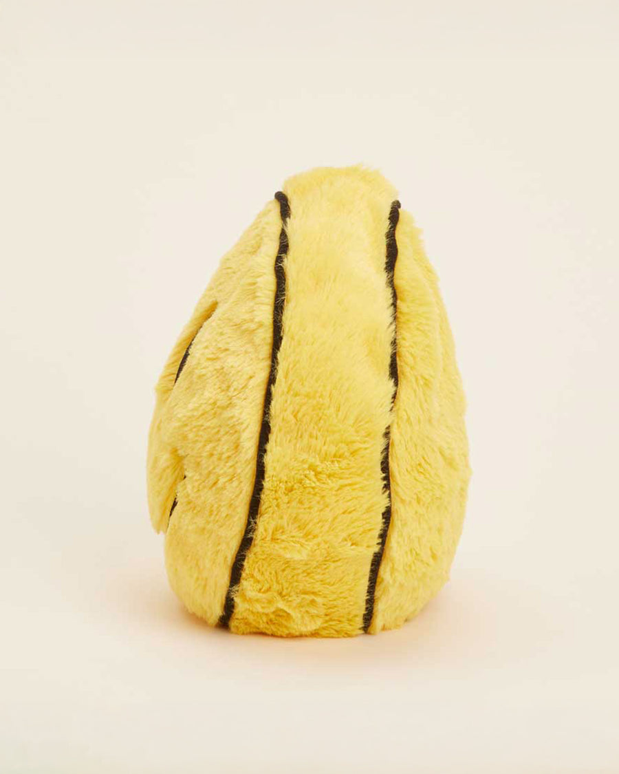 side view of yellow smiley face heating plush