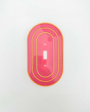 pink toggle light switch with yellow accents