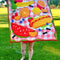 model holding completed picnic blanket themed quilted kit