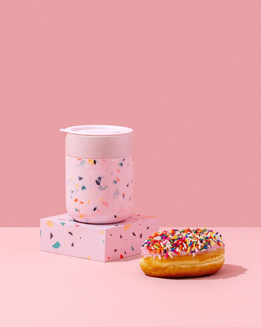 pink terrazzo portable mug next to a donut