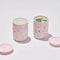 two pink terrazzo portable mugs with matcha inside