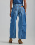 backview of model wearing high waisted wide leg denim with front seams large patch pockets and raw hem