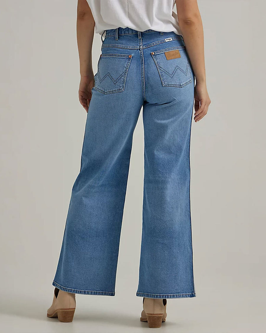 backview of model wearing light blue wide leg jeans