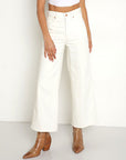 model wearing white wide leg jeans