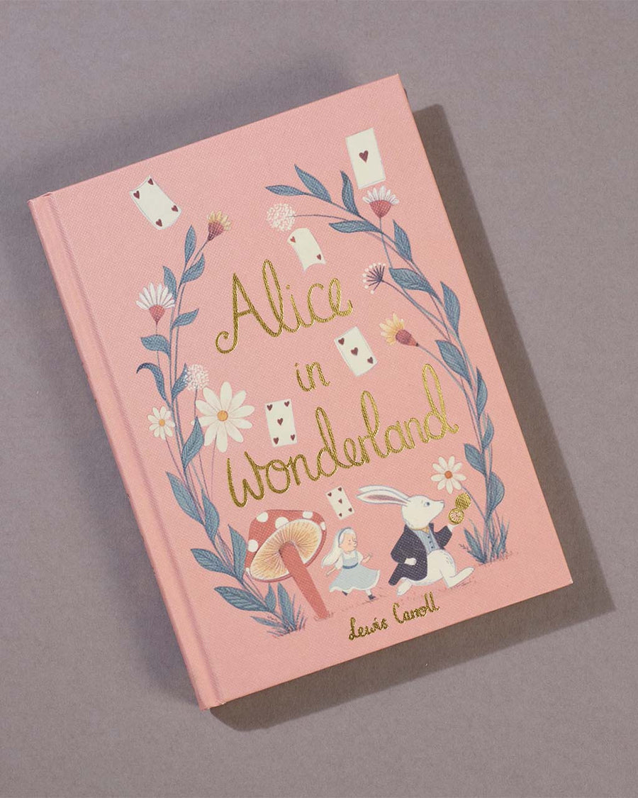 hardcover alice in wonderland book on a table
