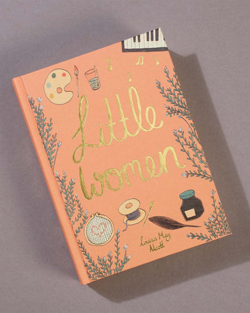 hardcover little women book on a table