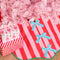 pink and red stripe tree skirt with three baby blue bows down the front and kelly green trim