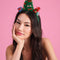 model wearing green tulle christmas tree with colorful bows, gold star and stacked christmas presents