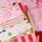 wrapping paper set with 16 double sided tags; 8 with stripes + 8 with all over icons under a tree