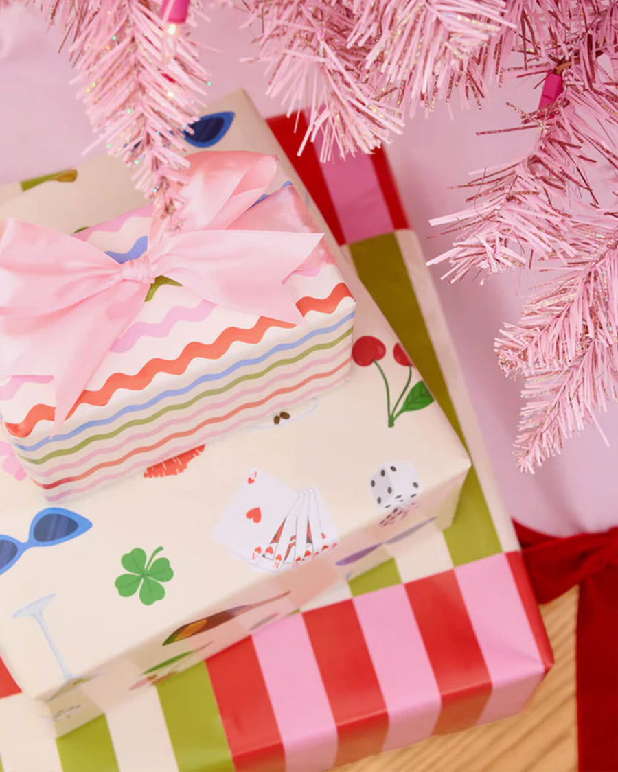 wrapping paper set with 16 double sided tags; 8 with stripes + 8 with all over icons under a tree