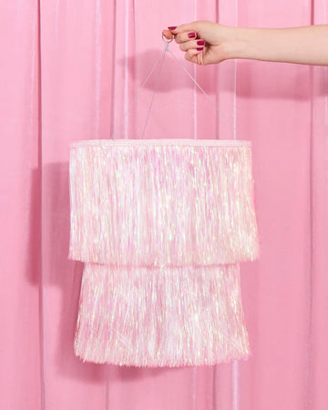 model holding iridescent shimmery fringe double tiered chandelier