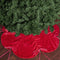 red velvet cinched tree skirt with red satin bows under a green holiday tree