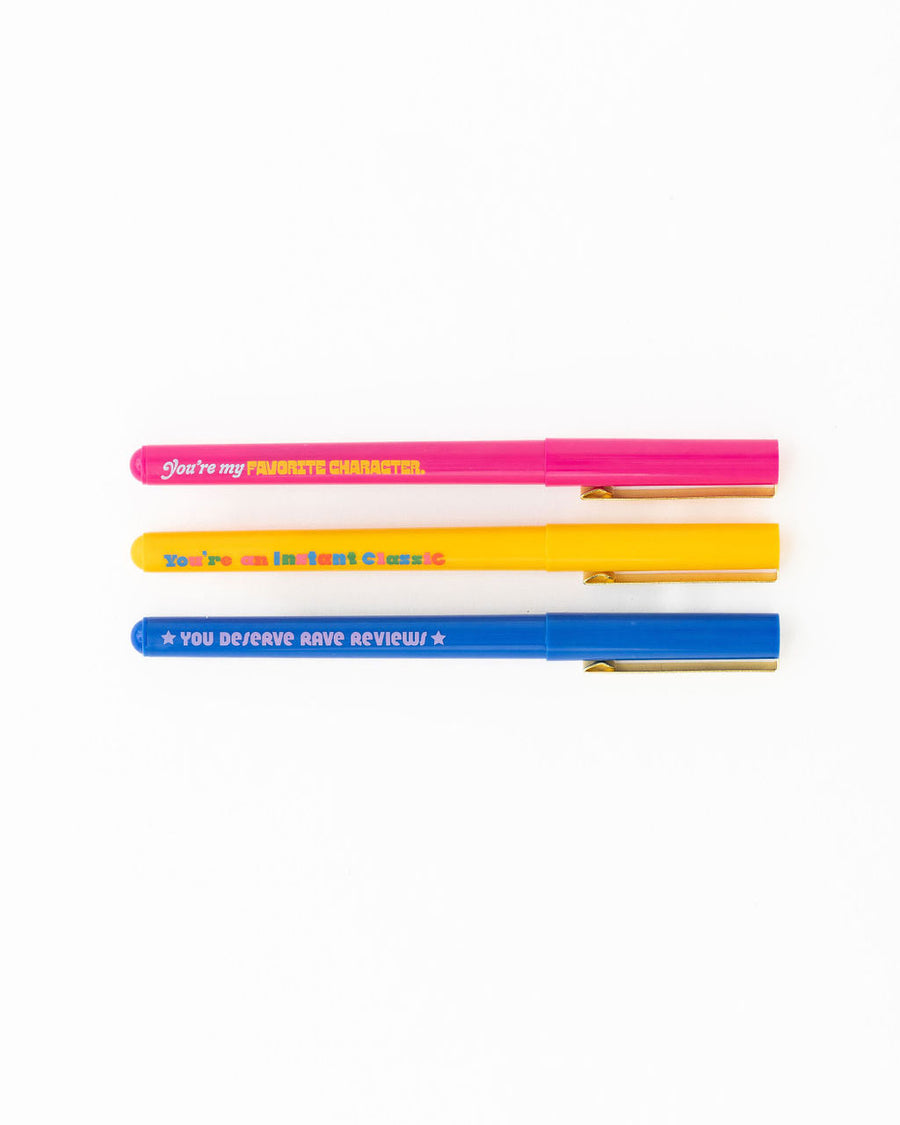 side view of set of three pens with book sayings: you're my favorite character', you're an instant classic', and 'you deserve rave reviews'
