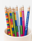 set of colorful pre-sharpened wood pencils with various book compliments on them in a cup