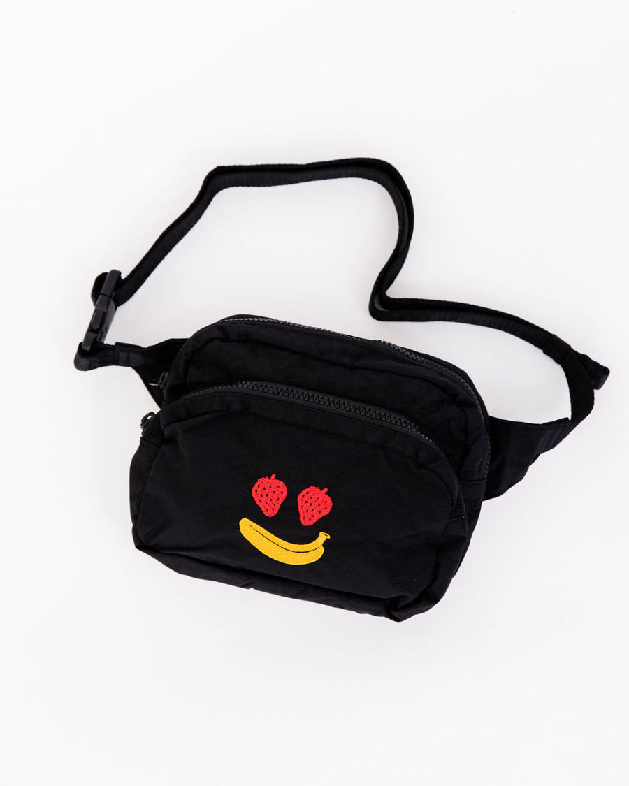 black fanny pack with strawberry eyes and banana smiley design