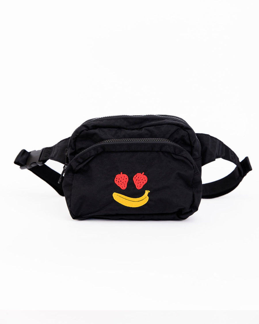 side view of black fanny pack with strawberry eyes and banana smiley design