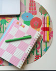 Closeup of planner opened to notes page, sitting on the floral desk pad
